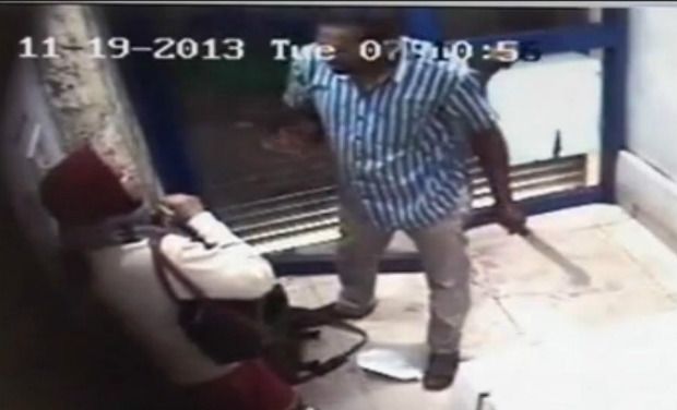 A CCTV image of the attacker attacking the woman with a revolver (on his right hand) and machete (left hand) at an ATM in Bengaluru. A CCTV image of the attacker attacking the woman with a revolver (on his right hand) and machete (left hand) at an ATM in Bengaluru.